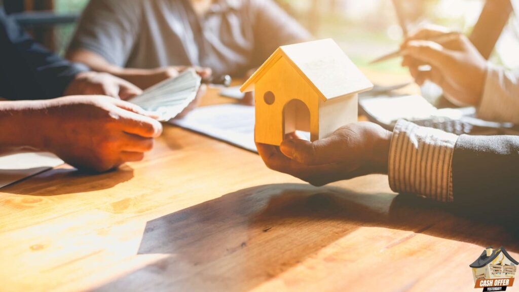 A home seller receiving cash while a buyer holds a miniature house, symbolizing the transaction of selling a house for cash - We Buy Houses in Arlington TX