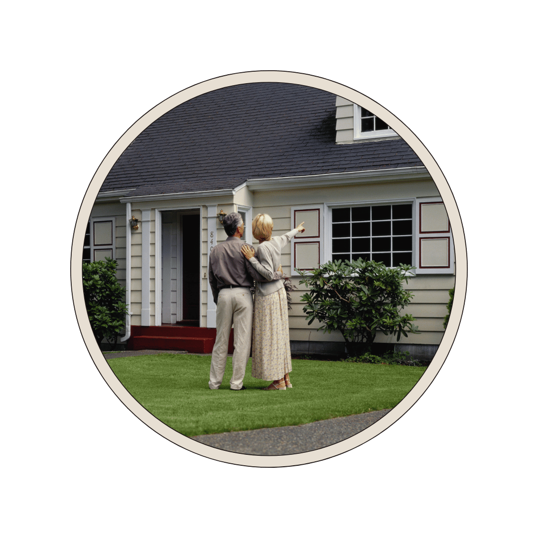 A couple standing with their backs to us, gazing at their house.