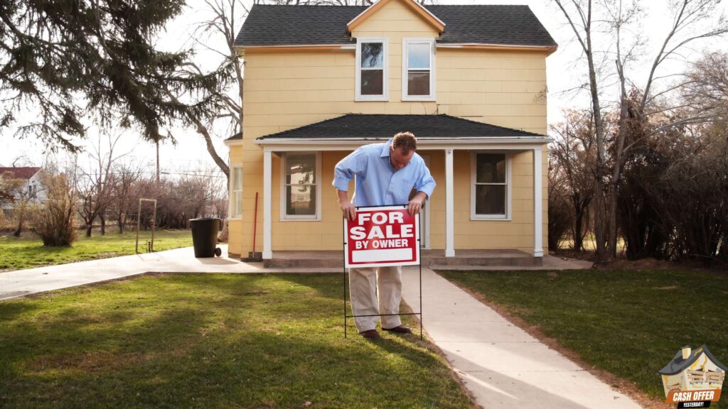 Man holding a 'For Sale' sign in front of his house - We Buy Houses in Decatur TX