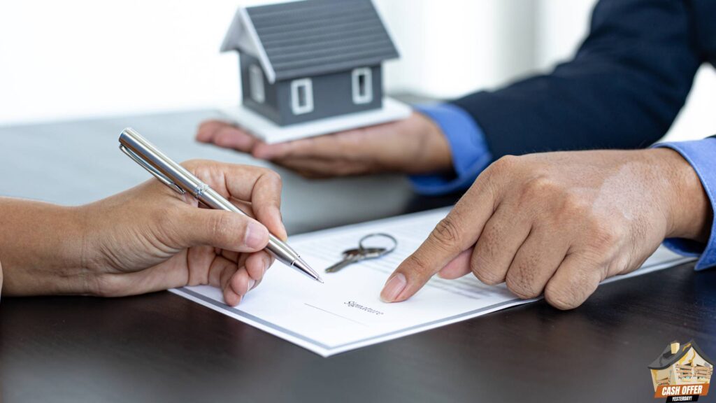 Realtor guiding a customer to sign paperwork while holding a miniature house - Sell Your House Fast in Decatur TX