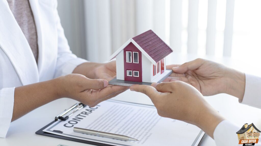 Two people lifting a miniature house, with a contract and pen on the table - We Buy Houses in Colleyville TX